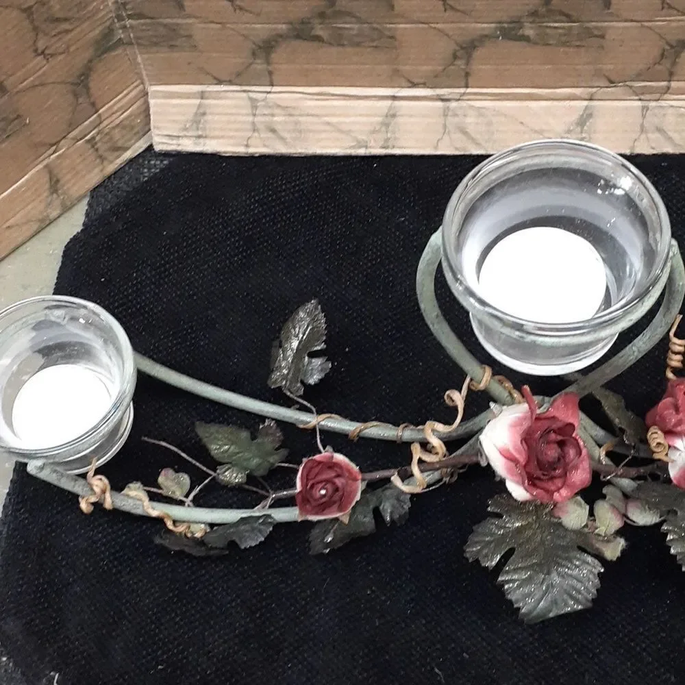 Long 3 candle black iron candle holder laced with trailing red roses.‎